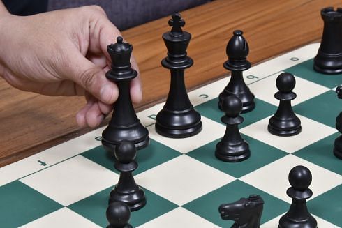Dark colored plastic chess pieces