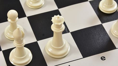 Plastic chess pieces in a Ivory White color
