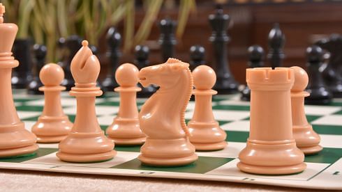Closer look of light colored plastic chess pieces